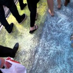 Marchers walking across a newly chalked rainbow crossing in the image of the painted one removed from a street in Sydney in April.