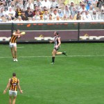 The sport is not a variation on American football whatsoever—players may only pass by kicking or, as the photo shows, by punching the ball.